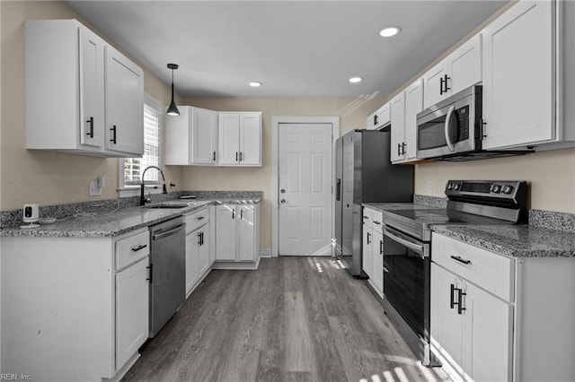 kitchen featuring appliances with stainless steel finishes, sink, and white cabinets