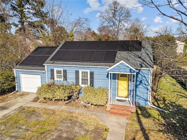 view of front of property featuring a garage and solar panels