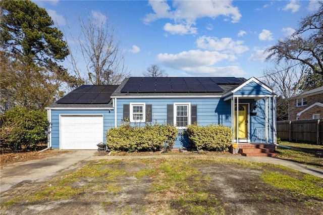 view of front of home with a garage and solar panels