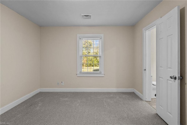 unfurnished room featuring light colored carpet