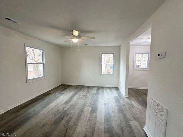 unfurnished room with ceiling fan and dark hardwood / wood-style floors