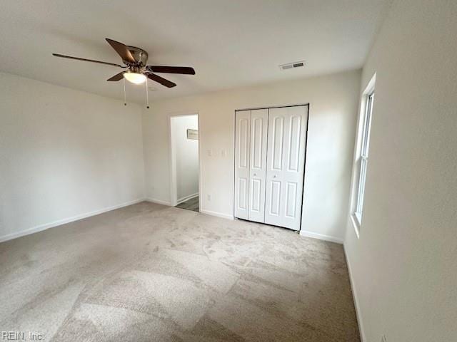 unfurnished bedroom with ceiling fan and carpet floors