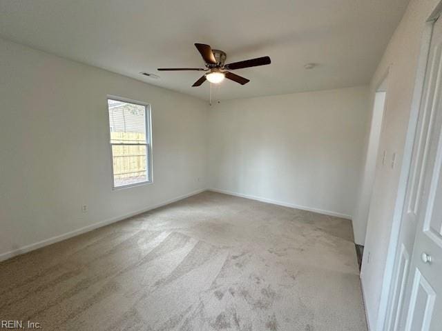 unfurnished room featuring ceiling fan and light colored carpet