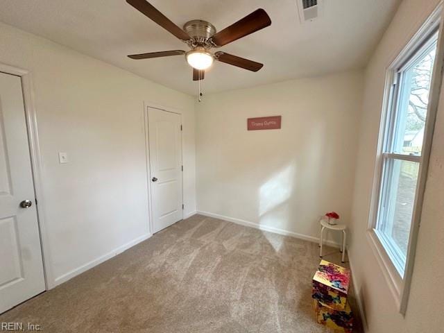 unfurnished bedroom with ceiling fan and light carpet