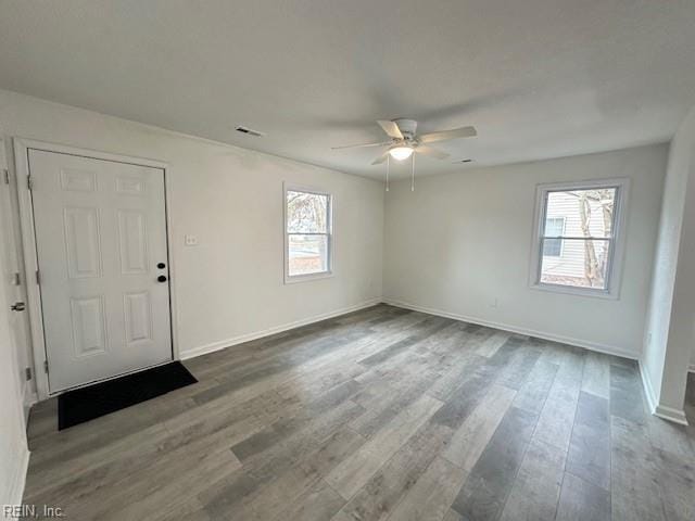 empty room with ceiling fan and hardwood / wood-style floors