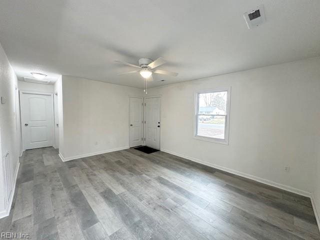 spare room with hardwood / wood-style floors and ceiling fan