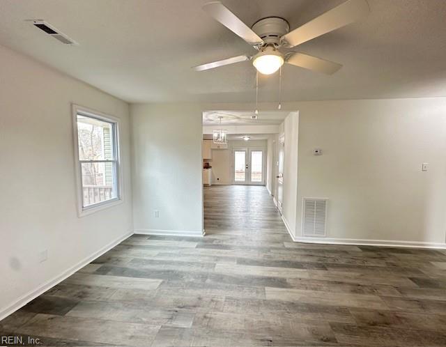 unfurnished room featuring ceiling fan, french doors, and hardwood / wood-style floors