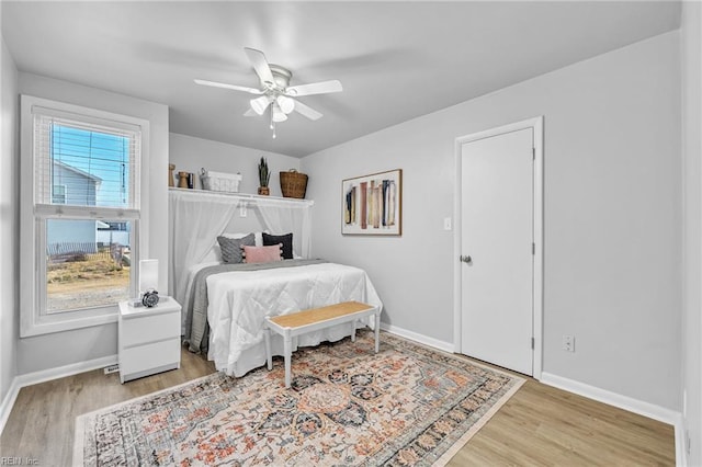 bedroom featuring light wood-type flooring and ceiling fan