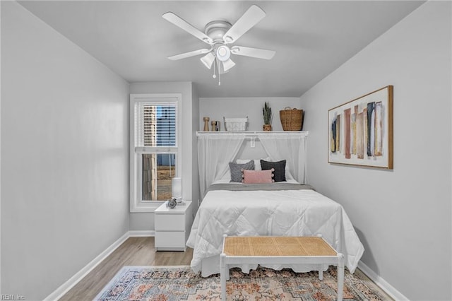 bedroom with light hardwood / wood-style flooring and ceiling fan