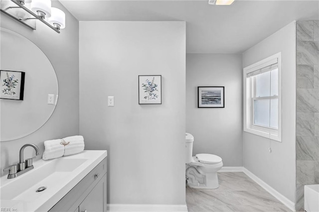 bathroom featuring vanity, a shower, and toilet