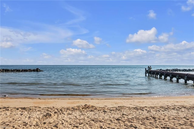 dock area with a view of the beach and a water view