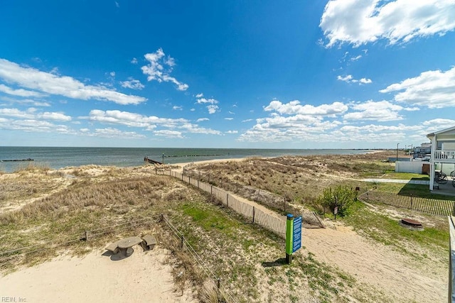 aerial view with a water view and a beach view