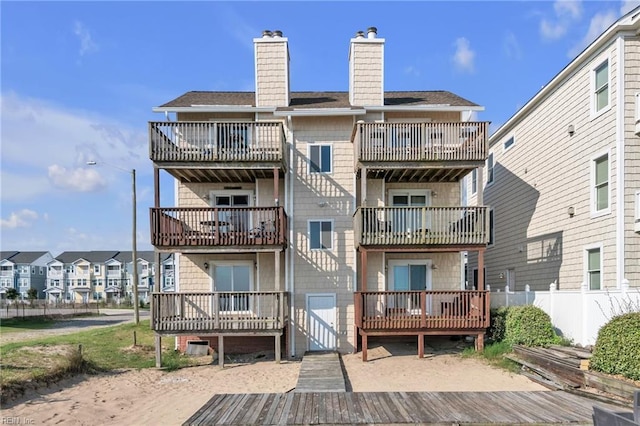 rear view of house with a balcony and a deck