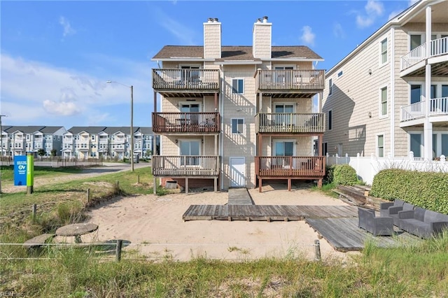 back of property featuring a wooden deck