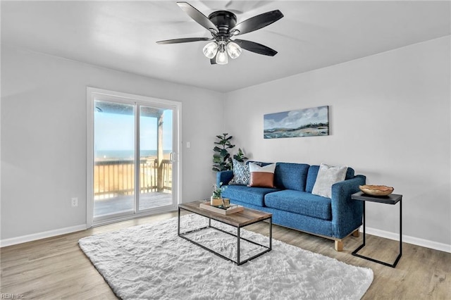 living room with ceiling fan and light wood-type flooring