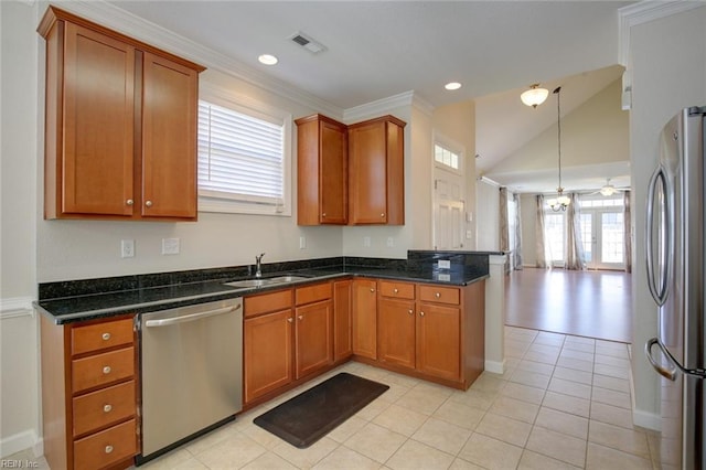 kitchen featuring light tile patterned floors, appliances with stainless steel finishes, sink, and dark stone counters