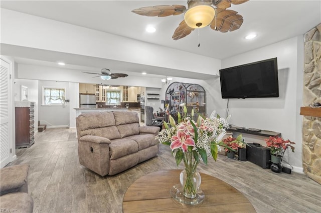 living room featuring light wood-type flooring and ceiling fan