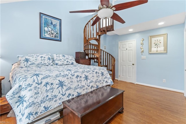 bedroom with ceiling fan and light hardwood / wood-style flooring