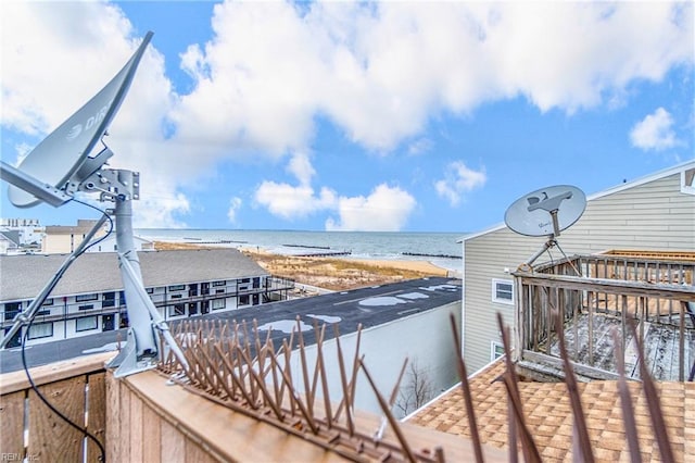 exterior space featuring a beach view and a water view