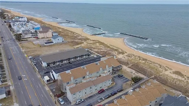 drone / aerial view with a water view and a beach view