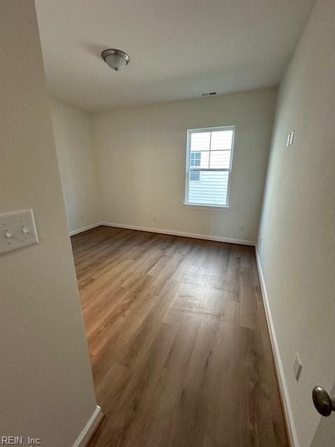 unfurnished room featuring hardwood / wood-style floors