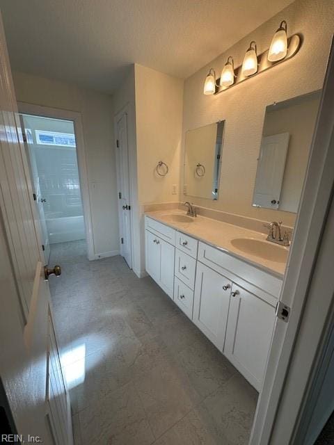 bathroom featuring vanity and a textured ceiling