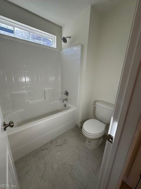 bathroom with toilet and bathtub / shower combination