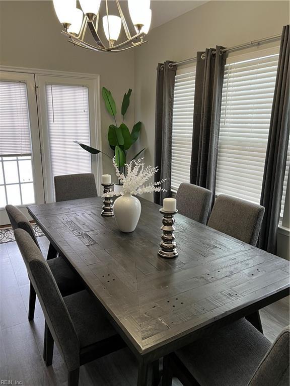 dining space featuring a chandelier and wood-type flooring