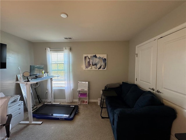 exercise room featuring light carpet