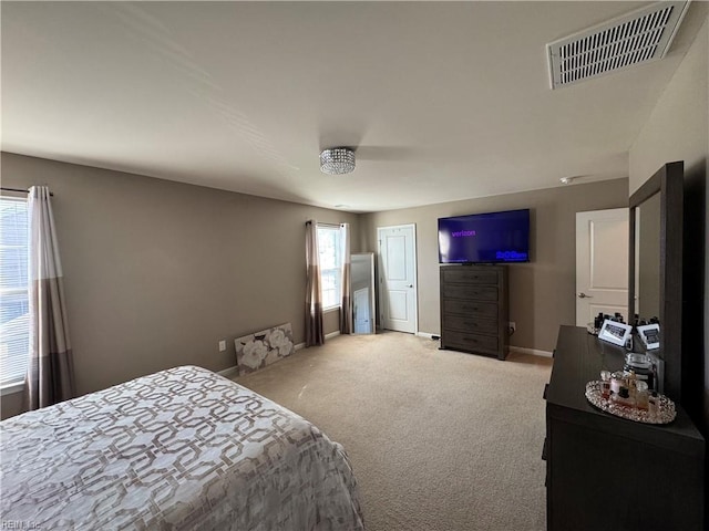 bedroom with ceiling fan and light carpet