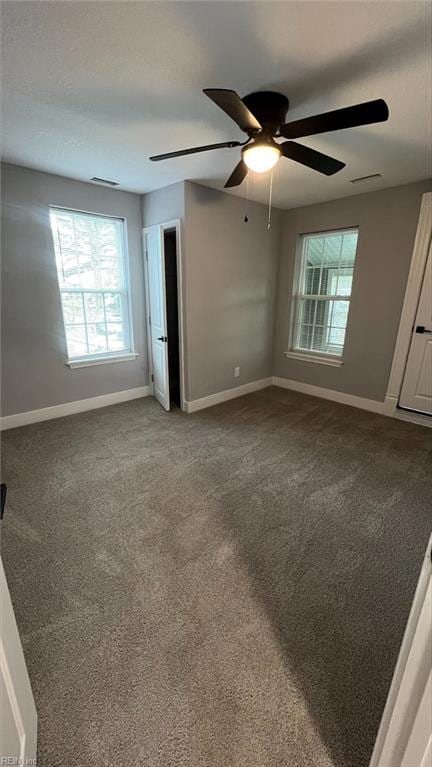 unfurnished bedroom with ceiling fan and carpet floors