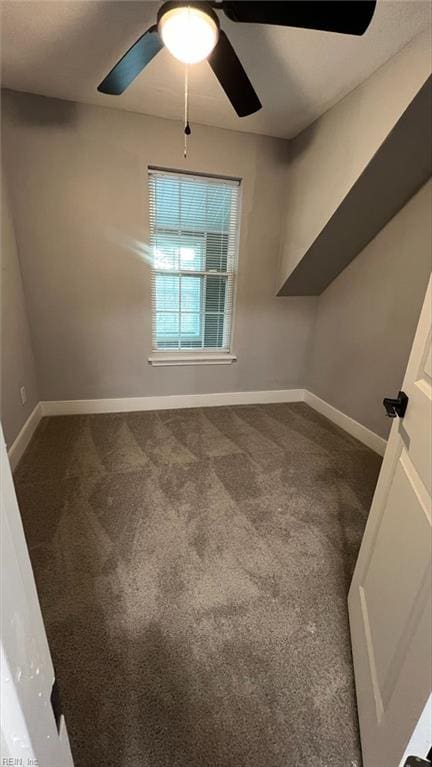 carpeted spare room featuring ceiling fan