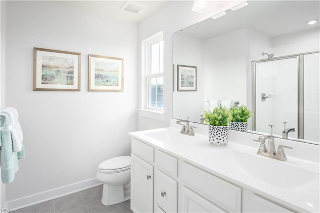 bathroom featuring walk in shower, vanity, toilet, and tile patterned flooring