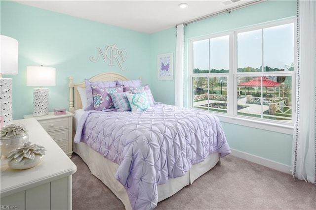 bedroom featuring light carpet