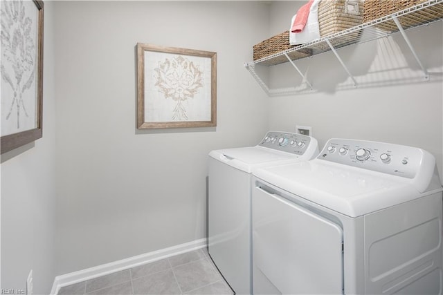 laundry area featuring light tile patterned flooring and washer and clothes dryer