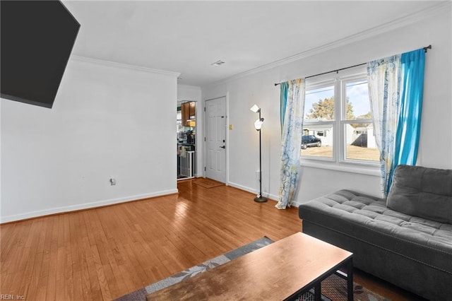 living room featuring hardwood / wood-style flooring and ornamental molding