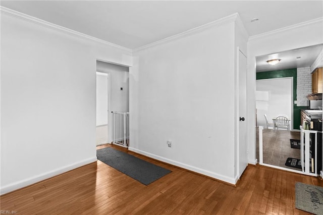 spare room with hardwood / wood-style flooring and ornamental molding