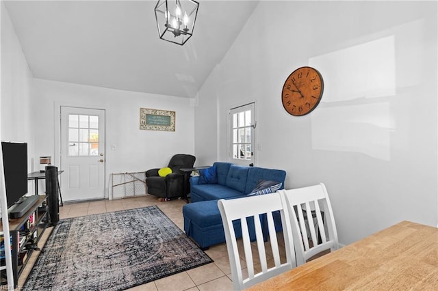 living room featuring a notable chandelier, high vaulted ceiling, and light tile patterned floors