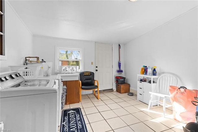 laundry room with ornamental molding, washing machine and dryer, and light tile patterned flooring