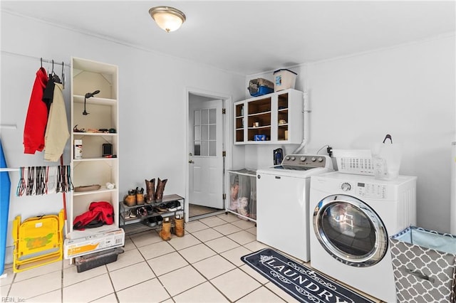 laundry area featuring light tile patterned flooring and washing machine and clothes dryer