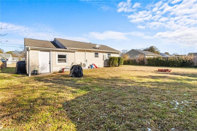 back of house featuring a yard