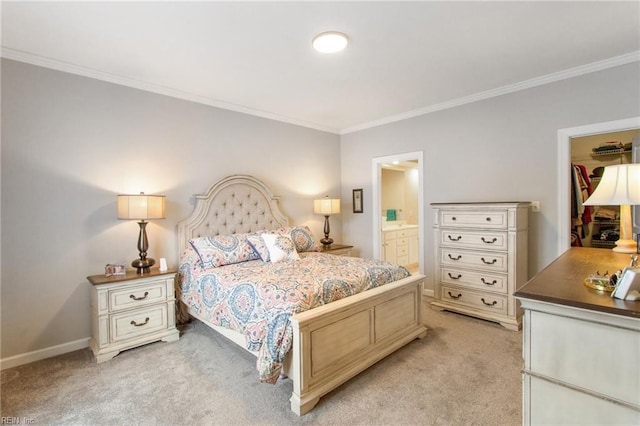 bedroom with crown molding, light colored carpet, and ensuite bath