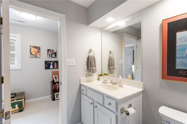 bathroom featuring vanity and toilet