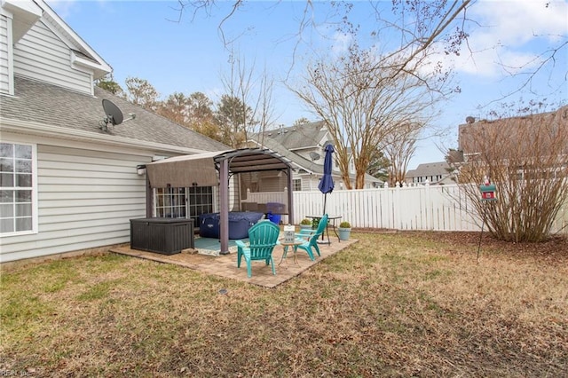 view of yard with a hot tub and a patio