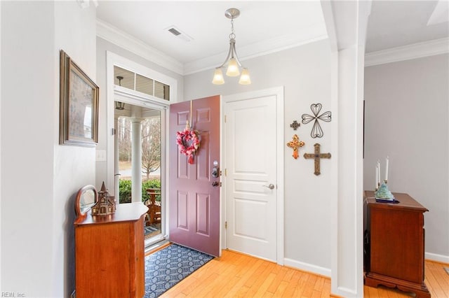 entrance foyer with crown molding and light wood-type flooring