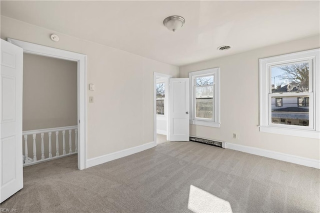 unfurnished room featuring light colored carpet and a wealth of natural light