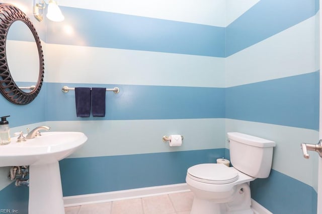 bathroom with sink, toilet, and tile patterned floors