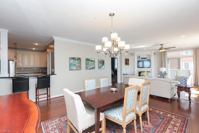 dining room with ceiling fan with notable chandelier, ornamental molding, and dark wood-type flooring