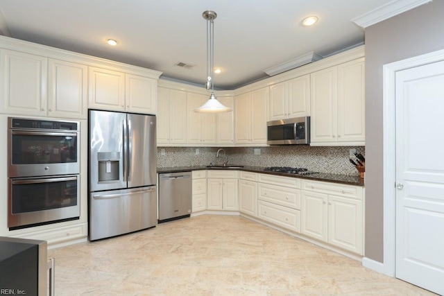 kitchen featuring sink, pendant lighting, decorative backsplash, and stainless steel appliances