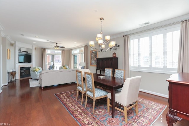 dining space with a wealth of natural light, ornamental molding, and a notable chandelier